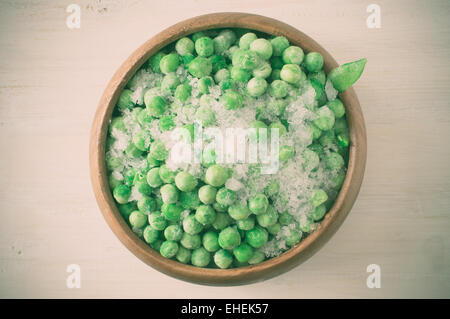 Frozen green peas with pieces of pods covered with frost Stock Photo
