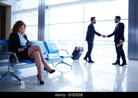 Colleagues meeting in the airport Stock Photo