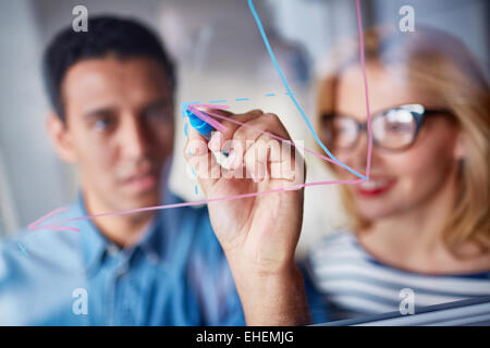 Man drawing a scheme on glass Stock Photo