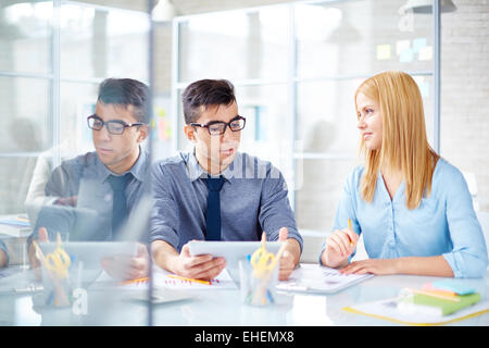 Two workers talking in office Stock Photo