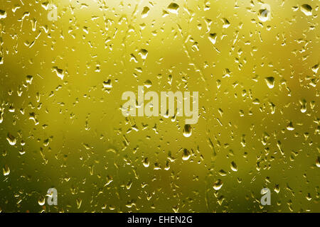 Download Water Drops On Glass With A Yellow And Gold Lighted Background Stock Photo Alamy Yellowimages Mockups