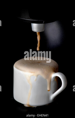 Coffee machine pouring hot espresso coffee in cup Stock Photo