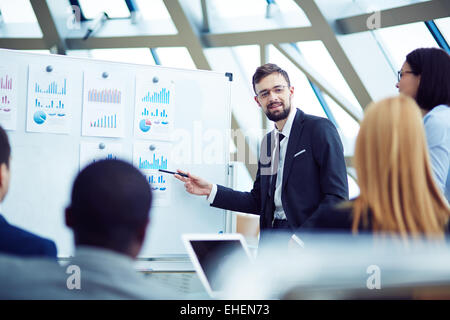 Young man Showing information to colleagues Stock Photo