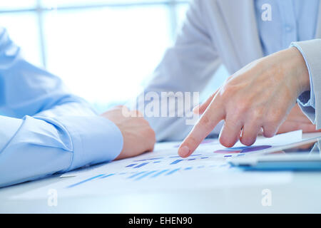 Close-up of male hand over documents Stock Photo