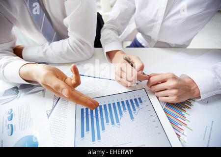Businesspeople analyzing statistics Stock Photo