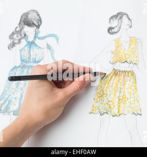 closeup of human hand drawing fashion design on paper Stock Photo