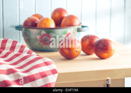 blood red oranges on kitchen table Stock Photo