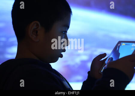The boy in the use of flat panel computer Stock Photo