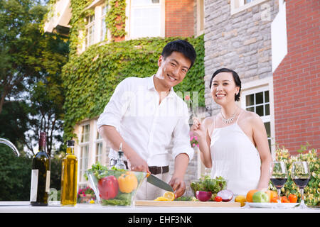 The young couple is cooking in the kitchen. Stock Photo