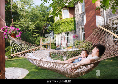 Happy family of three in the garden Stock Photo