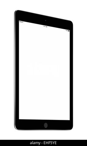 Bottom up view of rotated at a slight angle black tablet computer with blank screen mockup isolated on white background. High qu Stock Photo