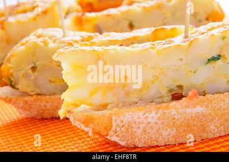 closeup of a plate with typical spanish pincho de tortilla, spanish omelete served on bread Stock Photo