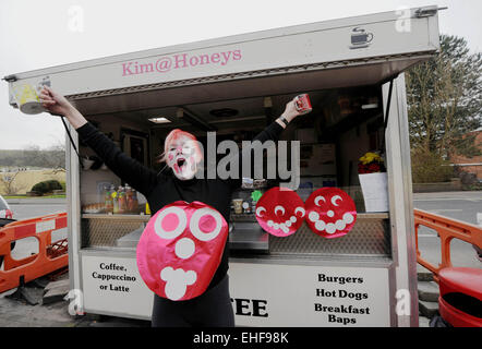 Brighton, UK. 13th March, 2015. Kim Coghlan is entertaining customers at her roadside cafe in Brighton today with her face painted for  the Comic Relief Red Nose charity day . Stock Photo