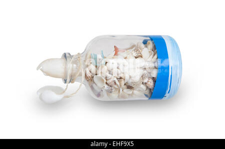 Glass bottle filled with sea shells, isolated on white Stock Photo