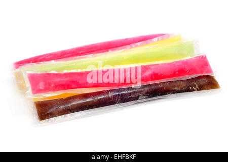some freezies of different colors and flavors on a white background Stock Photo
