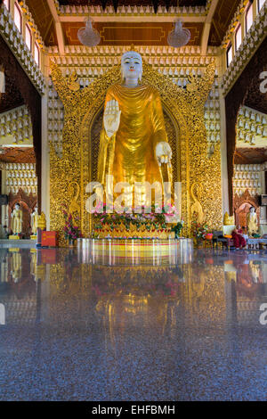 PENANG, MALAYSIA - MARCH 10, 2015: Large Gold Buddha Statue in Dhammikarama Burmese Buddhist Temple hall entrance. This is a pop Stock Photo