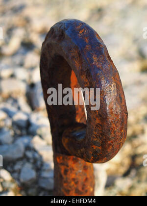 old and rusty mooring ring for ships on dock Stock Photo