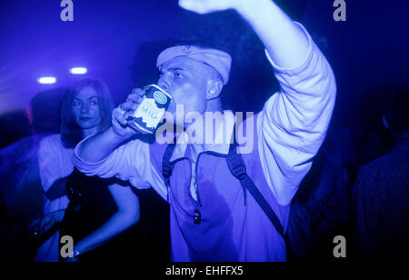 Man dancing whilst drinking milk at Colours at The Arches Glasgow 13th June 1998. Stock Photo