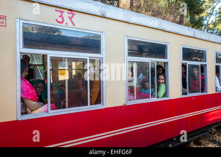 Young girl smiling from a carriage of the Kalka-Shimla narrow gauge train in India Stock Photo