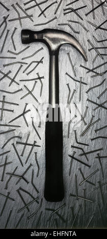 Hammer with bent nails on a silver slate background, scanned from a 10x8 transparency Stock Photo