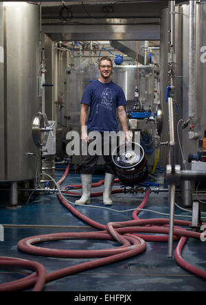 Staff holding Beer Barrel at the Camden Town Brewery London Stock Photo