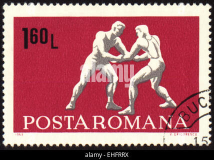 ROMANIA - CIRCA 1969: A post stamp printed in Romania shows wrestling Stock Photo