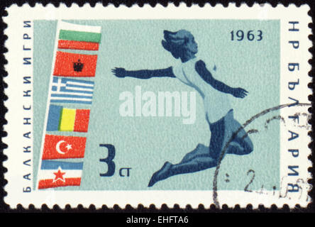 Stamp printed in Bulgaria shows jumping athlete Stock Photo