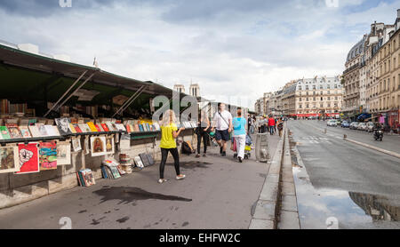 Paris, France - August 07, 2014: Small souvenir shops with walking people on the Seine river embankment in Latin quarter of Pari Stock Photo