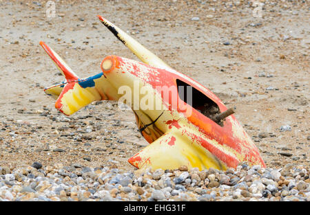 Part of a fairground ride wedged into the shingle on a beach. Stock Photo
