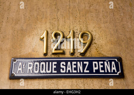 Argentina, Buenos Aires, 1219 Avenida Presidente Roque Sáenz Pena, house number and blue enameled road name sign Stock Photo