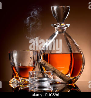 Decanter abd glass of alcohol and cigar on ashtray Stock Photo