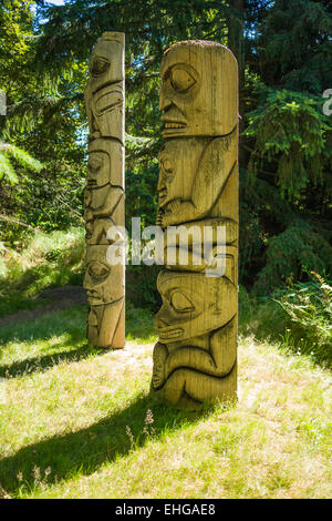 Totem poles near Forest Lake at Van Dusen Botanical Garden, Vancouver, BC, Canada Stock Photo