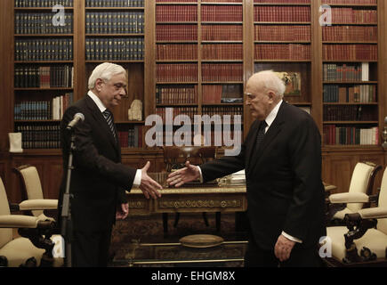 Athens, Greece. 13th Mar, 2015. Outgoing Greek President Karolos Papoulias (R) shakes hands with the newly elected President Prokopis Pavlopoulos during a handover ceremony at the Presidential Palace in Athens, Greece, on March 13, 2015. The new president of the Hellenic Republic, Prokopis Pavlopoulos, was sworn in on Friday. © Yannis Kolesidis/Pool/Xinhua/Alamy Live News Stock Photo