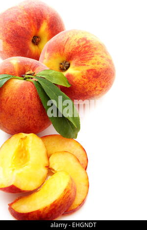 Ripe peach with green leaves. Stock Photo