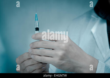 doctor with medical syringe in hand Stock Photo