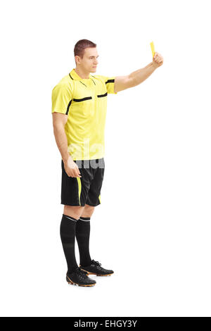 Full length portrait of a strict football referee standing over a ball ...