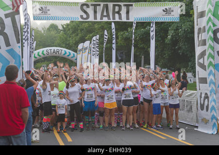 Excited Color Run racers before taking off from the starting line on July 26, 2014 in downtown Asheville, NC Stock Photo