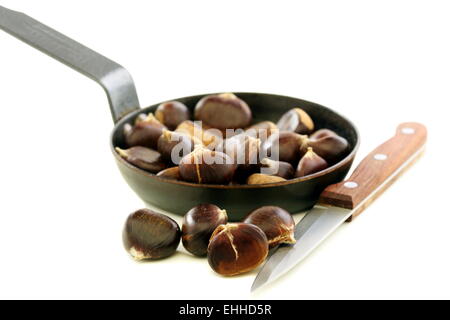 Knife and the chestnuts in a pan. Stock Photo