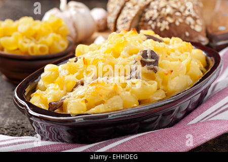 Macaroni with cheese, chicken and mushrooms baked in the oven Stock Photo