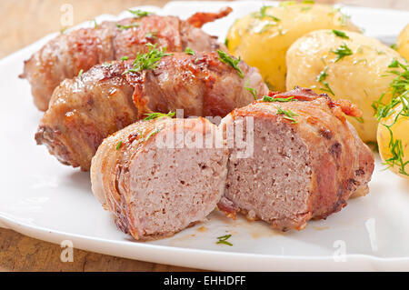 Grilled meat rolls wrapped in strips of bacon Stock Photo