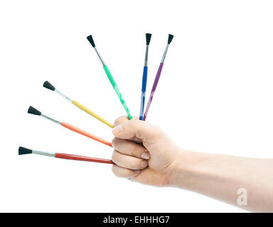 Caucasian male hand holding brushes Stock Photo