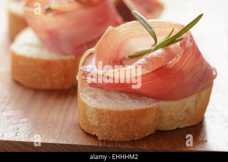 dried jamon slices on wood table, spanish food Stock Photo