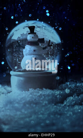 Snow globe in a snowy winter setting Stock Photo