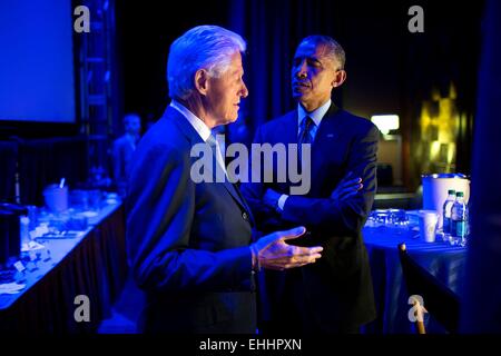 US President Barack Obama speaks with former President Bill Clinton backstage prior to delivering remarks during the Clinton Global Initiative September 23, 2014 in New York, N.Y. Stock Photo