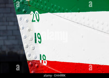 A colorful ship hull in green, white and red. Stock Photo