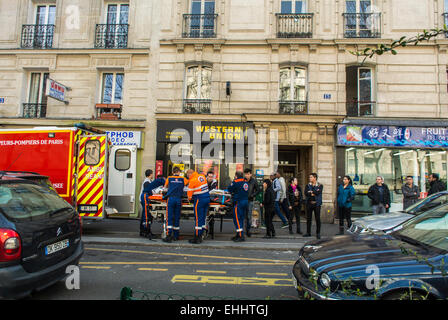 Paris, France, Chinese People Watching Firemen Emergency Crew removing accident victim from Building in Chinatown, Street Scenes, Belleville District,  street Paris in the daytime Stock Photo