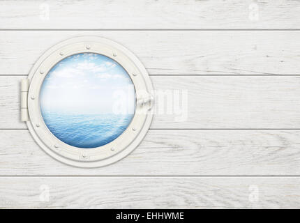 ship window or porthole on white wooden wall with sea or ocean horizon Stock Photo