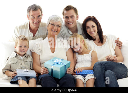 Family giving a present to grandmother Stock Photo