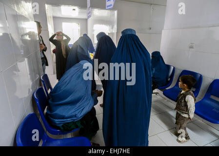 Women in burkas wait for treatment in the corridor of Central Hospital of Afghan Red Crescent Society, Kabul, Afghanistan Stock Photo