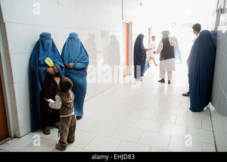 Women in burkas wait for treatment in the corridor of Central Hospital of Afghan Red Crescent Society, Kabul, Afghanistan Stock Photo